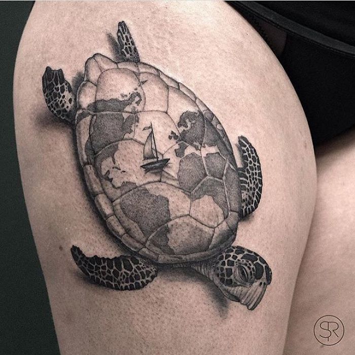 Sea turtle tattoo with world map design, featuring a sailboat, symbolizing travel inspiration.
