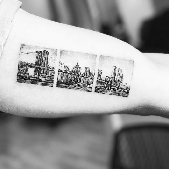 Travel tattoo featuring a scenic city skyline split into three panels on an arm.