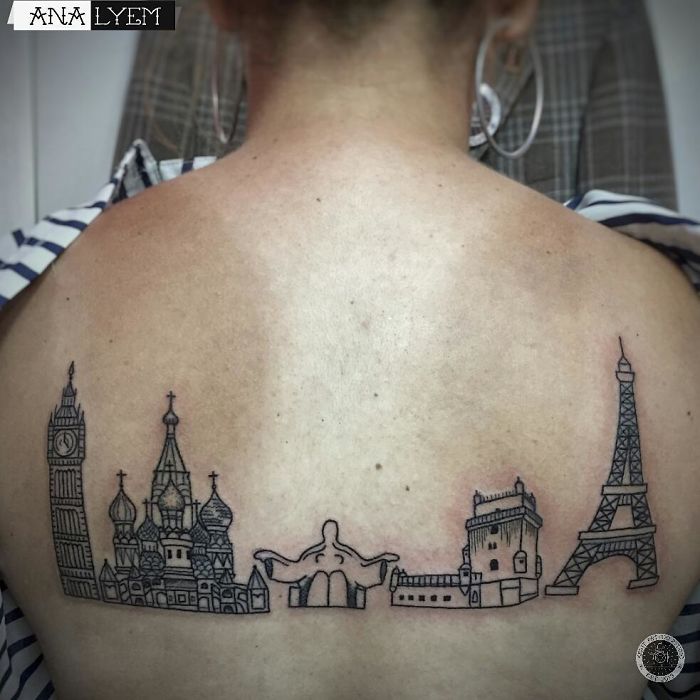 Back tattoo featuring iconic travel landmarks like Big Ben and Eiffel Tower, inspiring travel adventures.
