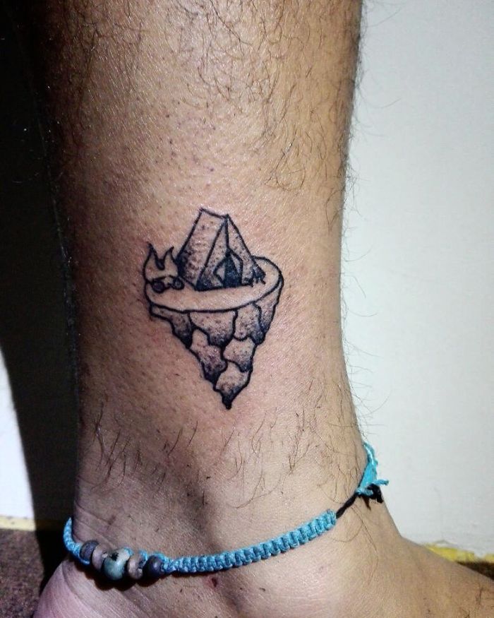 Travel tattoo featuring a small tent on a floating island, symbolizing adventure and exploration.