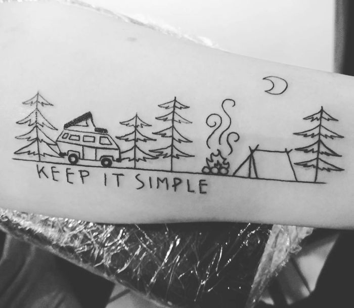 Travel tattoo featuring a camper van, pine trees, campfire, tent, and crescent moon with "Keep It Simple" quote.