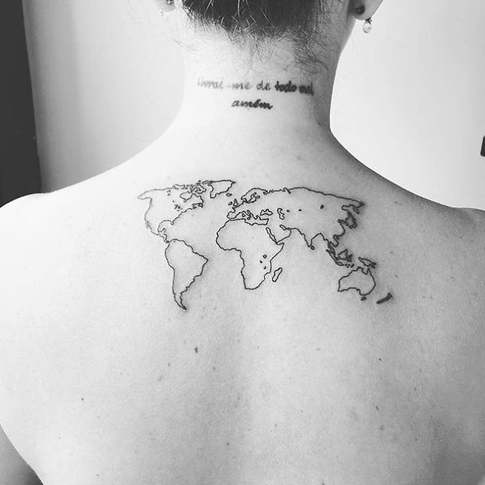 World map tattoo on a person's back, symbolizing a love for travel and adventure.