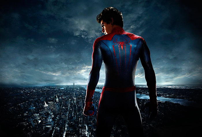 Spider-Man stands overlooking a cityscape at night in a scene from The Amazing Spider-Man movie for fun facts about movies.