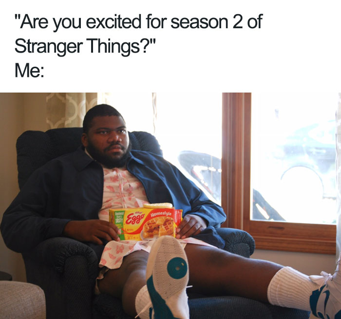 Man lounging in a chair, holding Eggo waffles, referencing a Stranger Things meme.