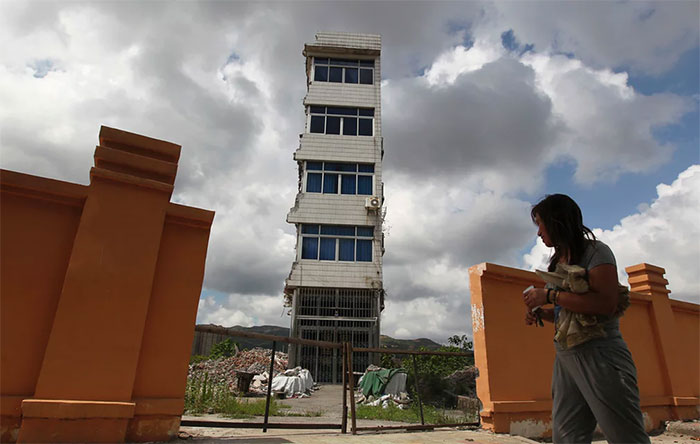 Zheng Meiju Outside Her Nail House In Rui’an, Zhejiang Province, In July 2013. She Has Been Living In The Partially Demolished Home For Nearly A Year, Even Though The Water And Electricity Supply Were Cut