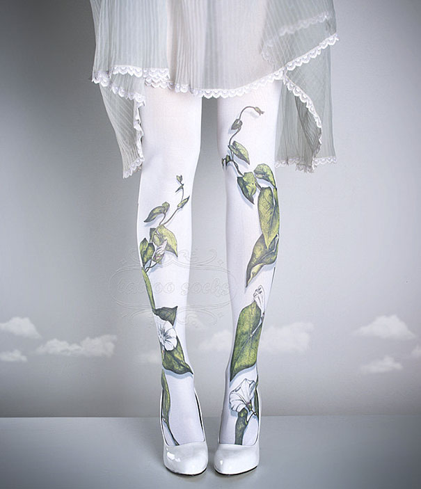 Tattoo socks featuring floral designs worn under a sheer skirt and white heels, ideal for those who love tattoo art.