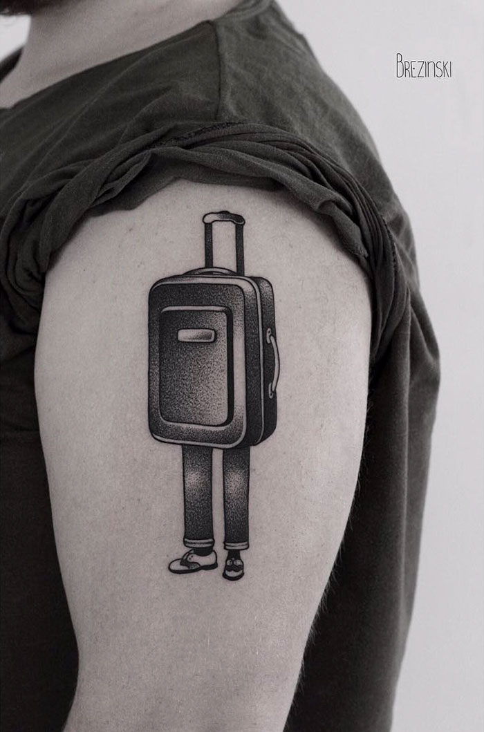 Travel tattoo of a suitcase with legs on a person's arm, symbolizing a love for adventure and wanderlust.