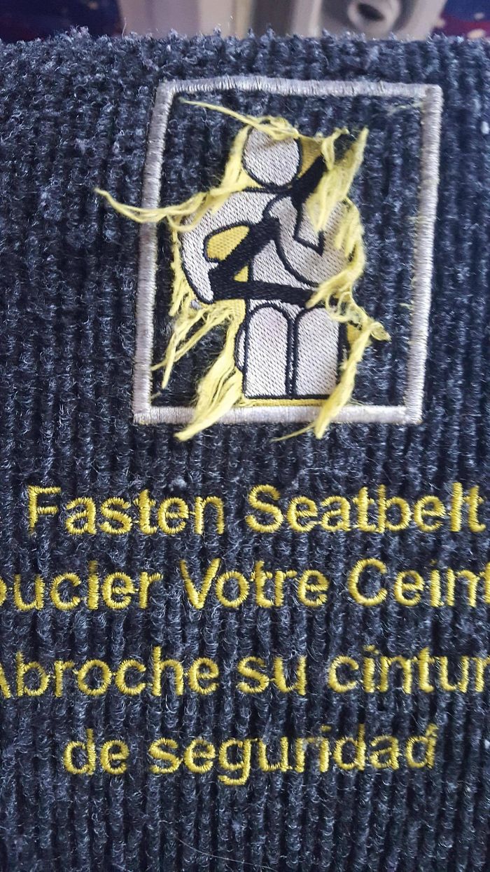 The Seat Belt Warning On This Bus Is Worn, Now The Figure Appears To Have Luscious Locks