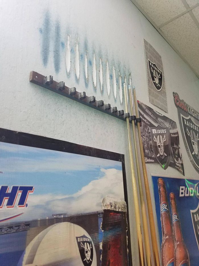 The Wall Is Worn From People Putting The Pool Cues In The Rack Over The Years