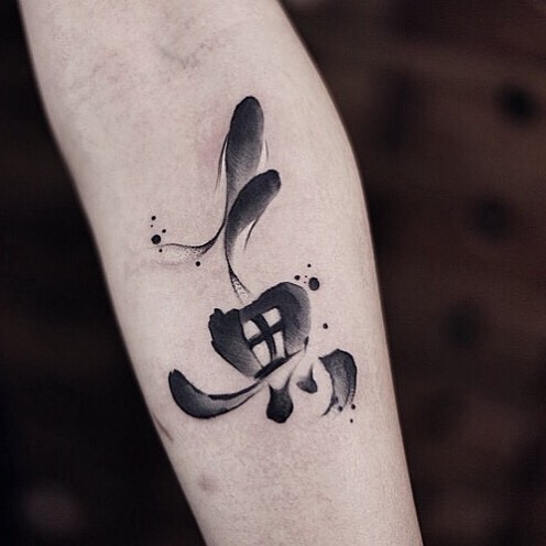Watercolor tattoo on forearm by Chen Jie, featuring abstract black ink design with fluid brushstrokes.