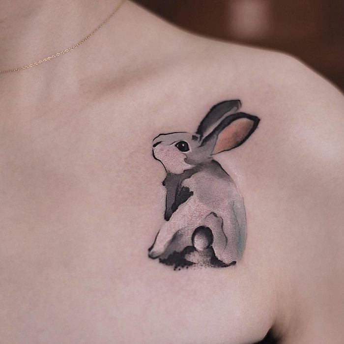 Watercolor tattoo of a rabbit on skin, showcasing Chen Jie's artistic style.