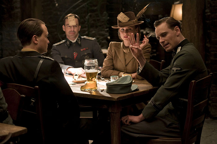 Scene from Inglourious Basterds movie showing characters playing a tense game, featured in fun facts about movies.