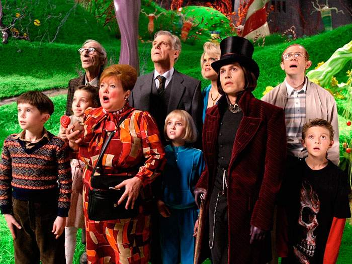Scene from Charlie And The Chocolate Factory movie showing a group of characters amazed inside the colorful factory, fun facts about movies.