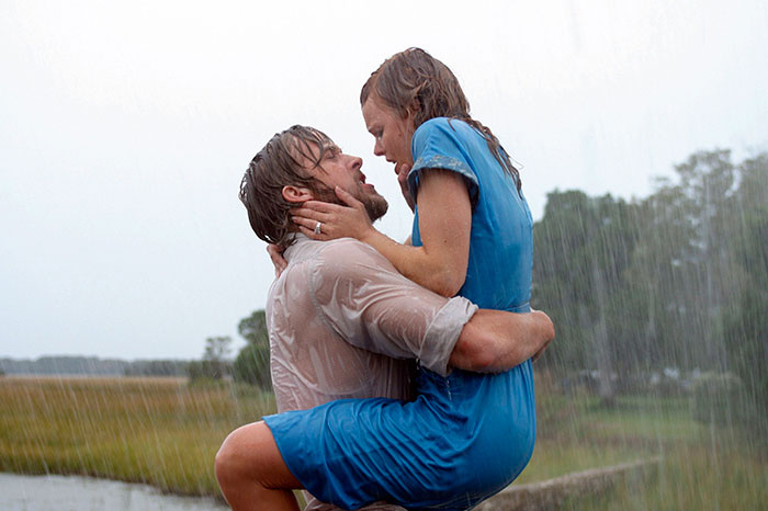 Romantic scene from The Notebook movie showing a couple embracing passionately in the rain, highlighting fun facts about movies.