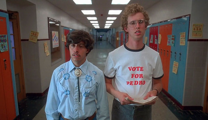 Scene from Napoleon Dynamite movie showing two characters in a school hallway, related to fun facts about movies.
