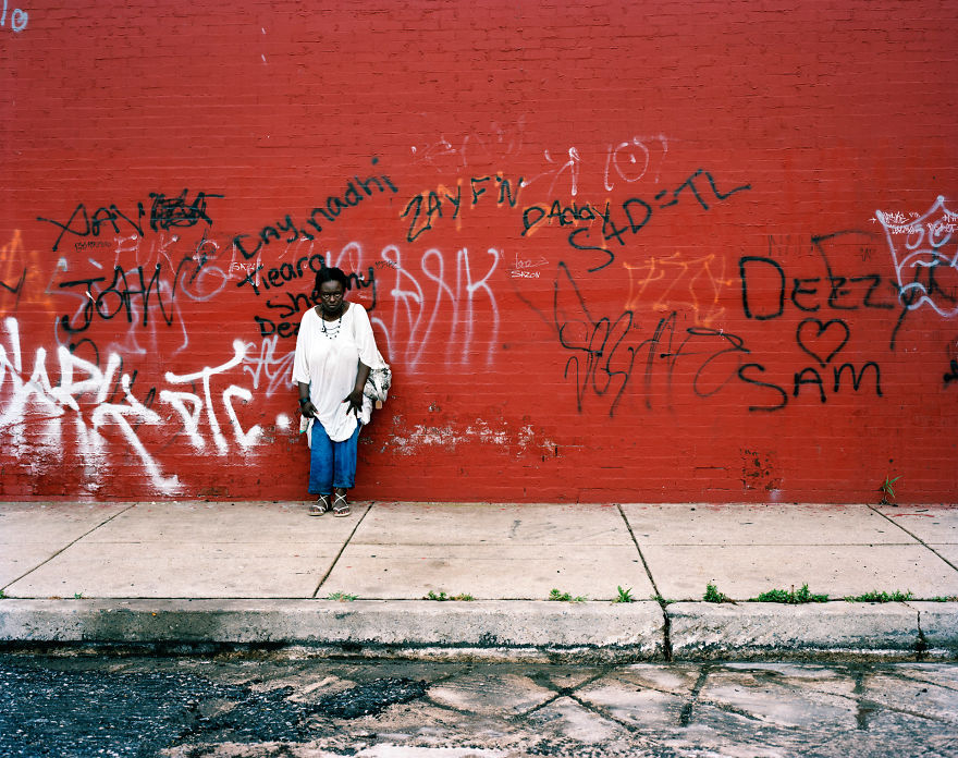 Woman posing on red East Sterner street