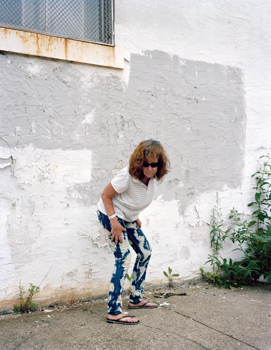 Photography of Sara posing near concrete wall