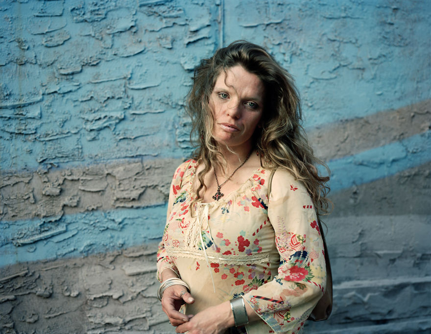 Portrait of Mary near blue and grey concrete wall