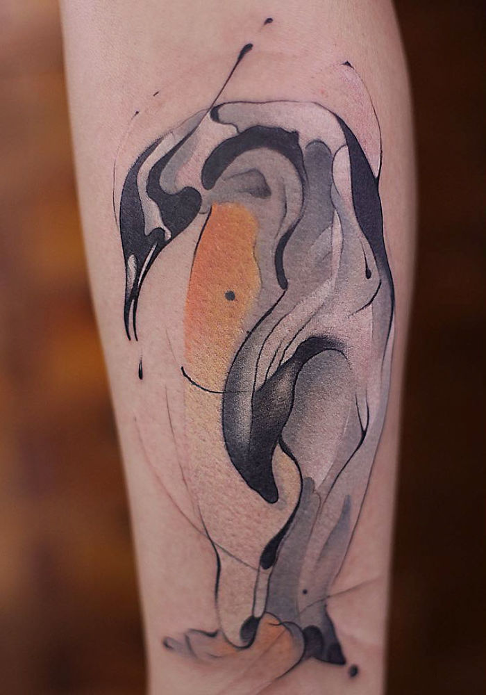 Watercolor tattoo by Chen Jie featuring abstract brushstrokes on skin, showcasing intricate design and vibrant colors.