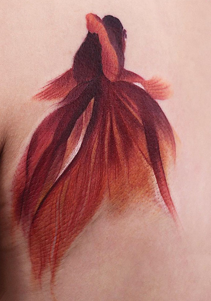 Elegant watercolor tattoo of a red betta fish by Chen Jie.
