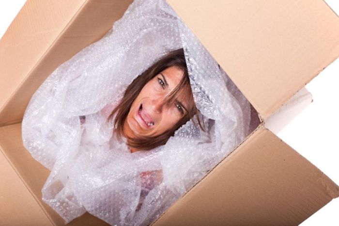 Woman crying packed in a box