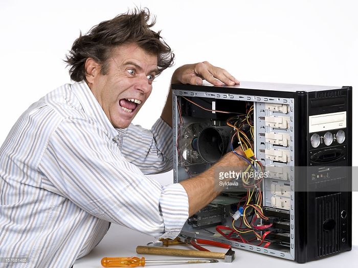A crazy man opened the computer's insides and put an arm in it