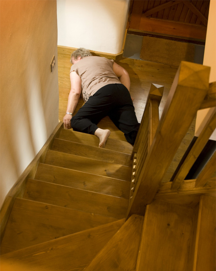 A man lying down near wooden stairs