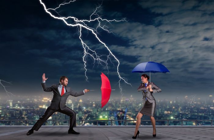 A couple in classy outfits with umbrellas are on the rooftop and lightning strikes in the night sky