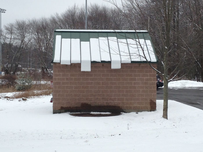 The Snow Is Sliding Off The Roof Of This Shed In A Mildly Interesting Manner