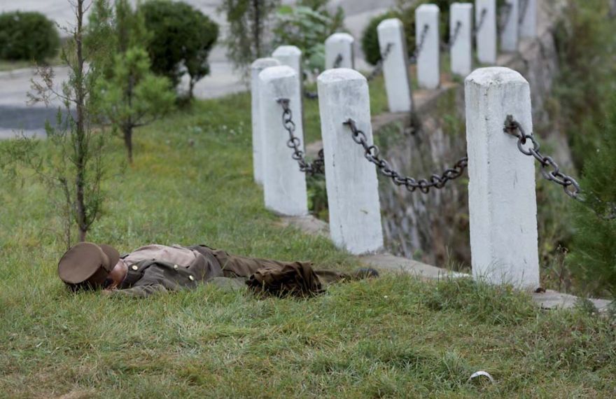 A soldier sleeping in a field 