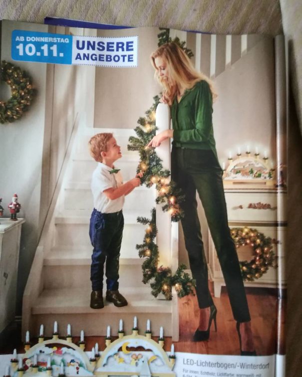 Woman and child decorating staircase with Christmas garland, featuring hilarious and disastrous Photoshop fail in a festive setting.