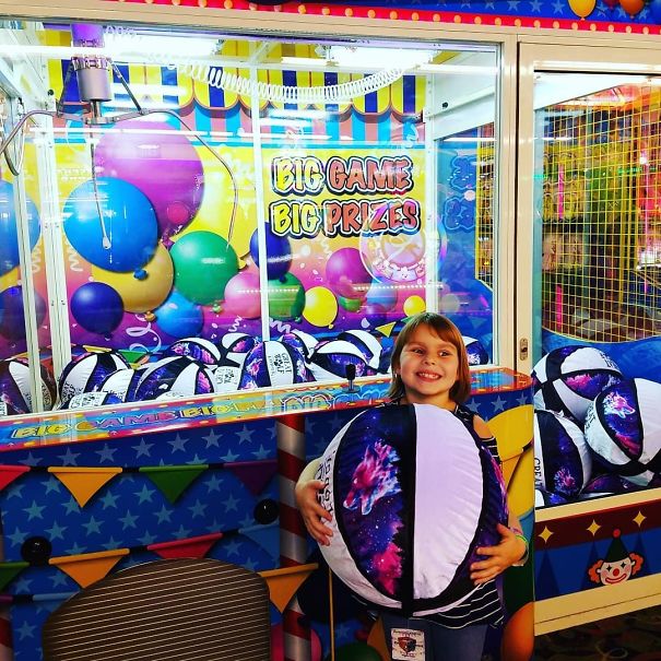 Back At The Arcade, She Wants To Play This Huge Claw Machine, I Say Sure Thinking There Is No Way She Will Get One An I Will Have To Carry That Huge Thing Around. I Was Wrong