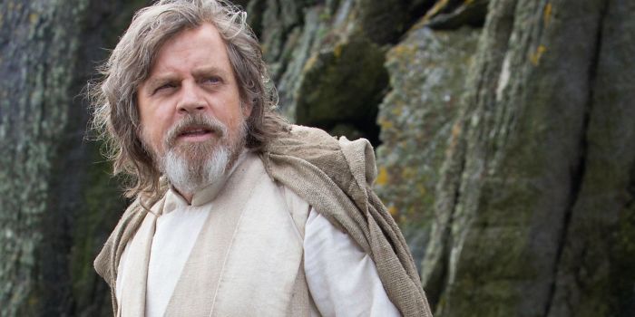 Scene from Star Wars The Last Jedi featuring a character in rustic clothing amid a rocky outdoor setting, movie fun facts theme.