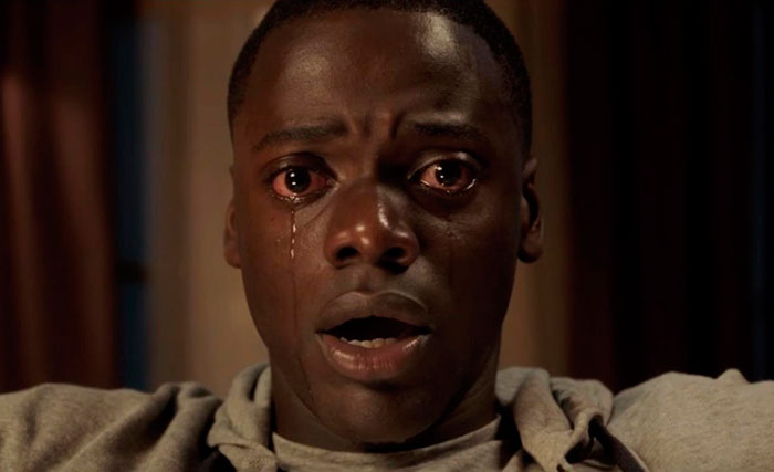 Close-up of a distressed man crying in a tense scene from the movie Get Out, illustrating intense movie facts.