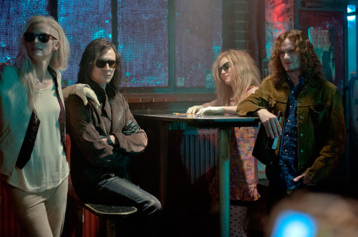 Scene from Only Lovers Left Alive movie featuring characters in sunglasses at a dimly lit bar, highlighting fun facts about movies.