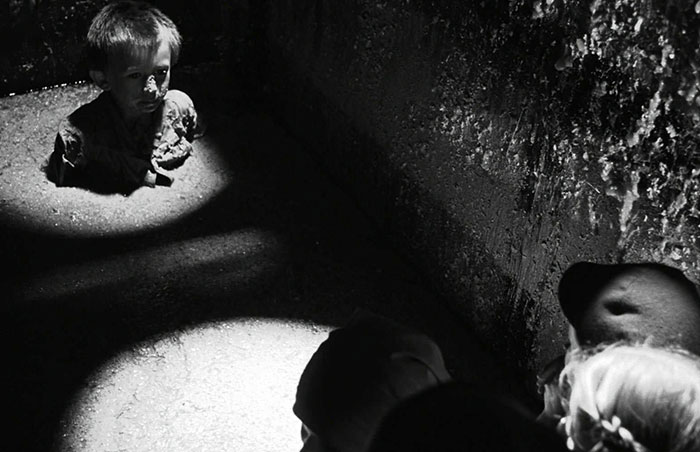 Scene from Schindler's List movie showing a child in a dark setting, highlighting emotional impact in movies fun facts.
