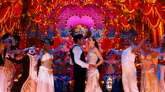 Scene from Moulin Rouge movie featuring a vibrant musical performance, highlighting fun facts about movies.