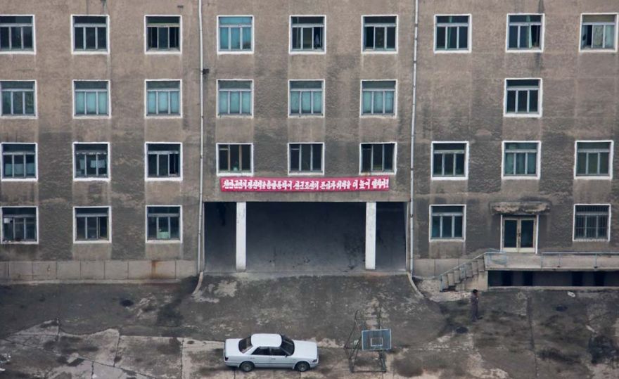 A grey building with red banner on it 