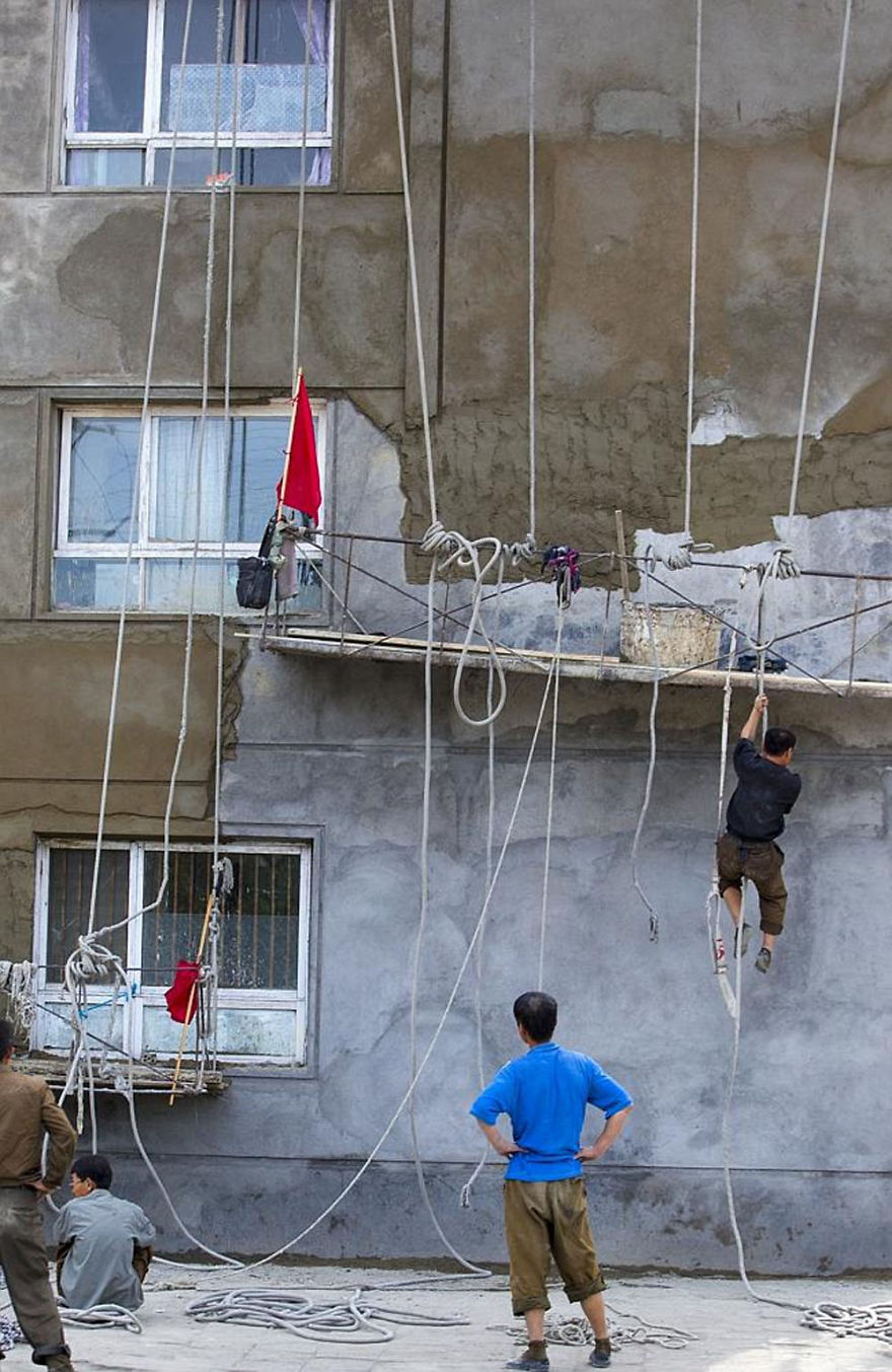 A worker climbing down the building 