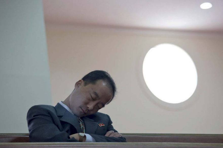 A man dozing off on a bench