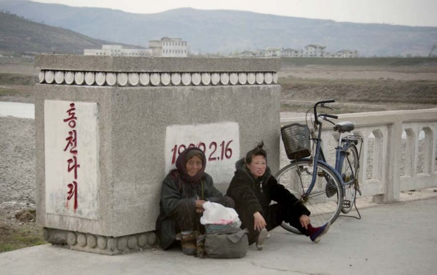 Two women sitting on the ground 