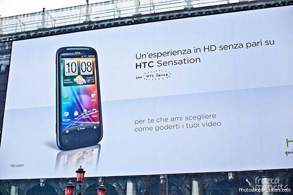 Large outdoor billboard featuring an HTC smartphone with a reflection error, showcasing a hilarious and disastrous Photoshop fail.