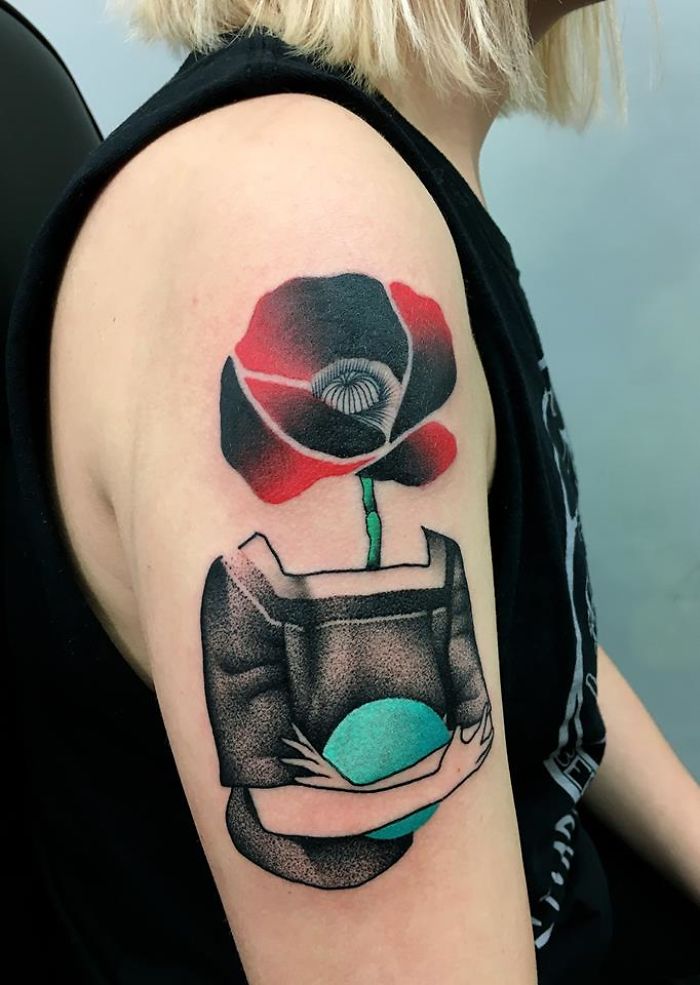 Tattoo of a red and black flower merging with human form, symbolizing the relationship between nature and humans.