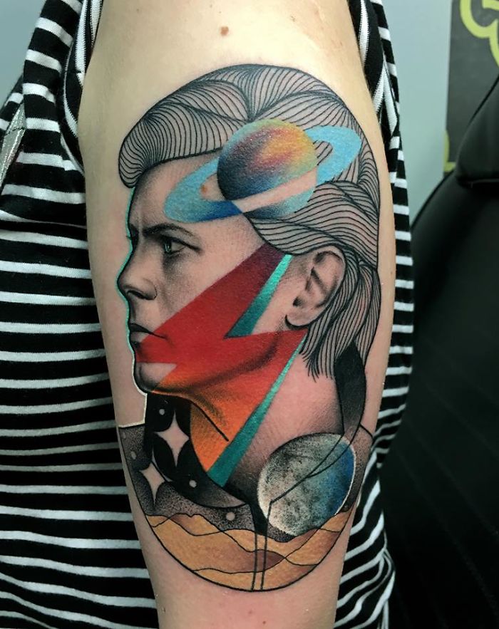 Colorful tattoo illustrating the connection between nature and humans, featuring celestial and abstract elements.