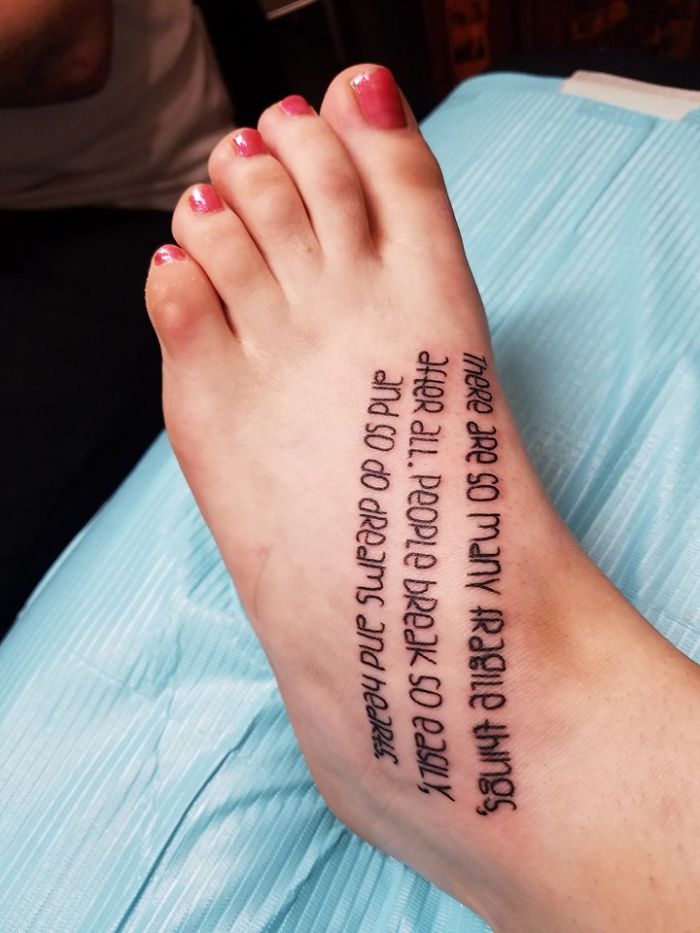 Tattoo of a quote about fragility on a foot with pink nail polish, showcasing personal stories behind tattoos.