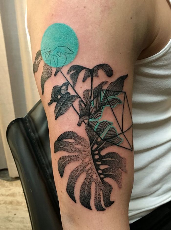 Nature and human relationship tattoo featuring leaves and geometric designs on an arm.