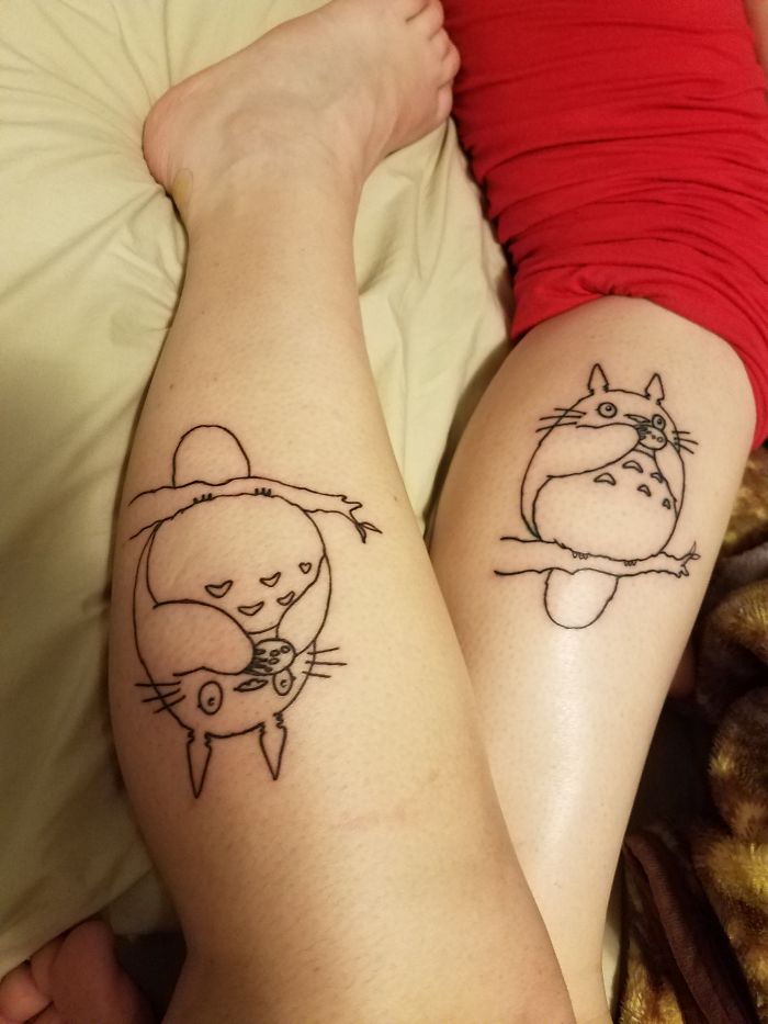 Tattoos of Totoro characters on two legs, highlighting personal tattoo stories.