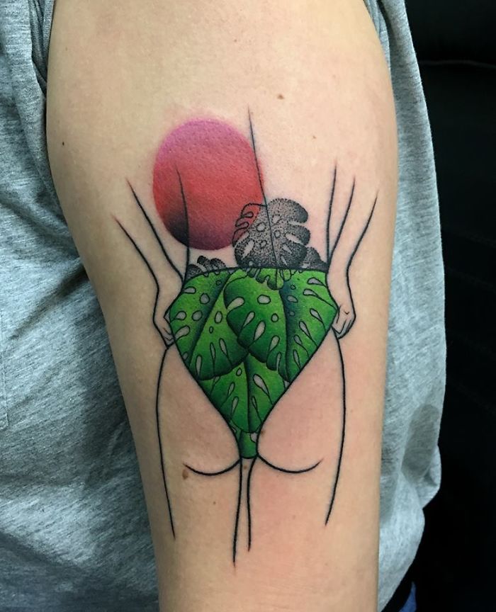 Tattoo of a human figure with plant leaves, symbolizing the relationship between nature and humans on the upper arm.