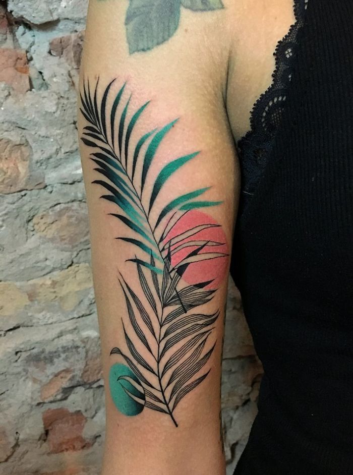 Tattoo of abstract nature design on arm, illustrating human-nature relationship.