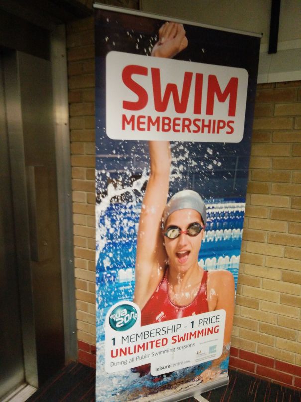 Poster showing a swimmer raising an arm with Photoshop fail making the arm appear unnaturally long in a swim membership ad.